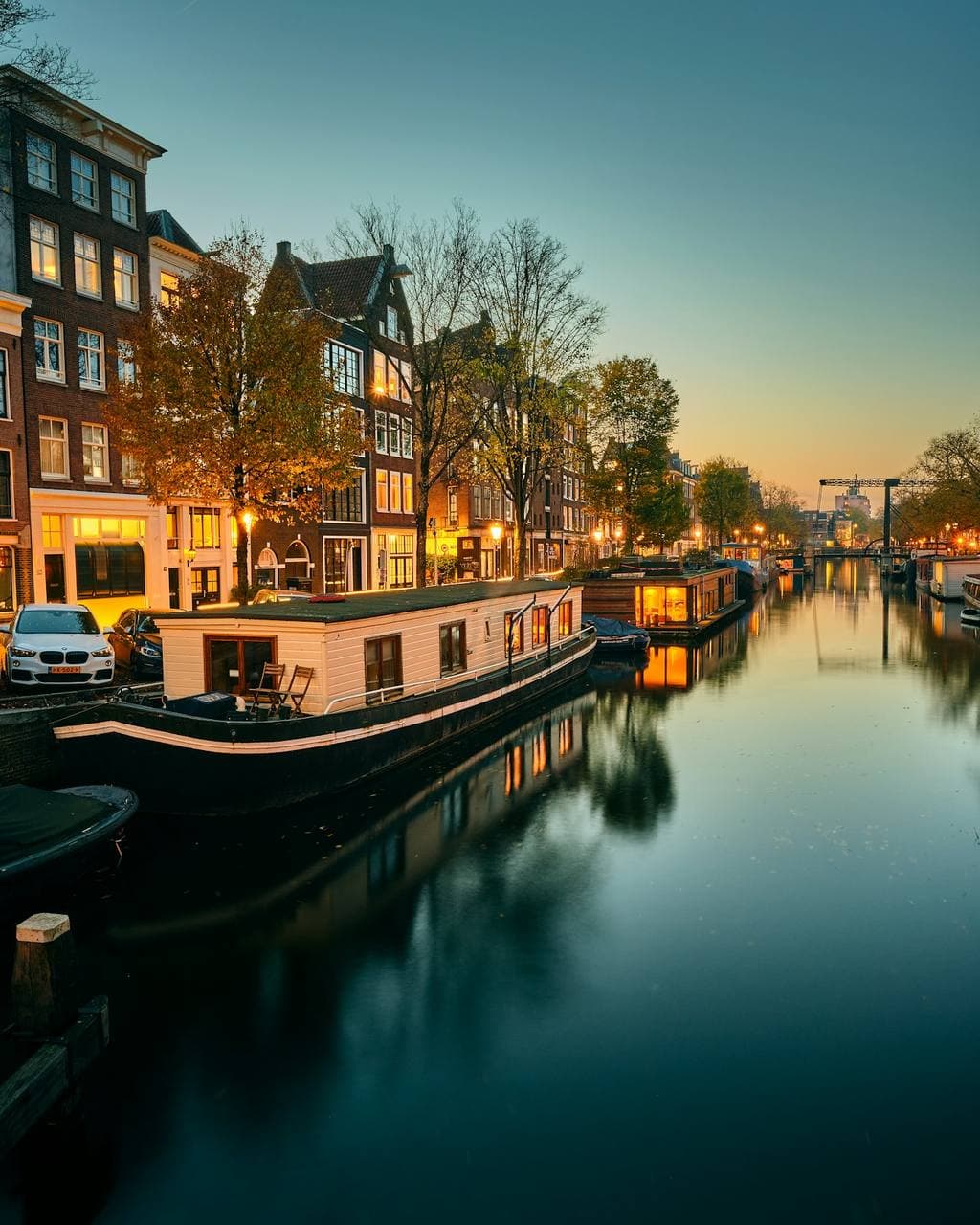 A houseboat on a quiet canal at dusk