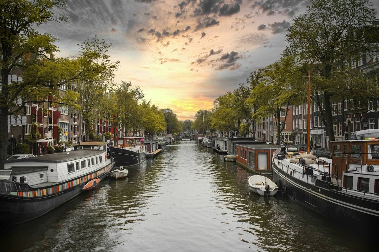 Houseboats moored on a canal at sunset