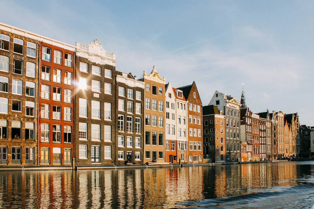 Sunlit canal houses along the water